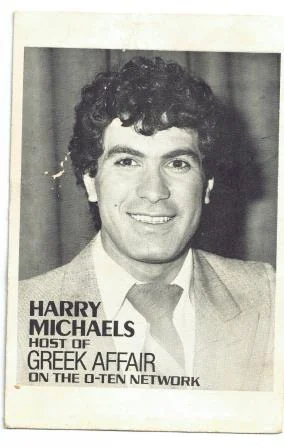 A yellowed press clipping headed ‘Harry Michaels, host of Greek Affair on the 0-Ten Network’, with a portrait of a smiling young man in a jacket and tie.